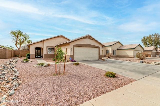 ranch-style home with a garage, driveway, fence, and stucco siding