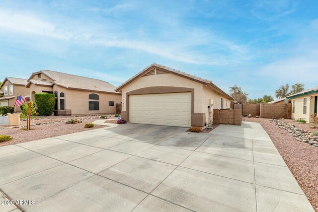 view of front of property featuring a tile roof, fence, and stucco siding