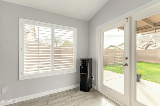 entryway with wood tiled floor, baseboards, and a wealth of natural light