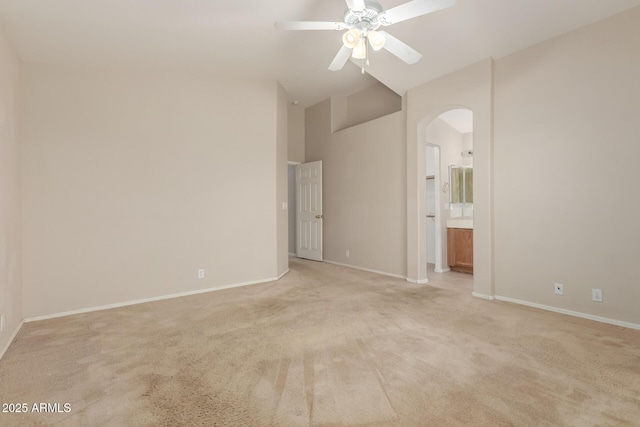 9243 W Brown St, Peoria, AZ 85345 - unfurnished bedroom with arched walkways, light colored carpet, baseboards, high vaulted ceiling, and ensuite bathroom