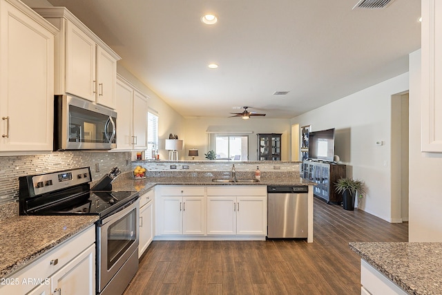 kitchen featuring white cabinetry, appliances with stainless steel finishes, sink, and kitchen peninsula