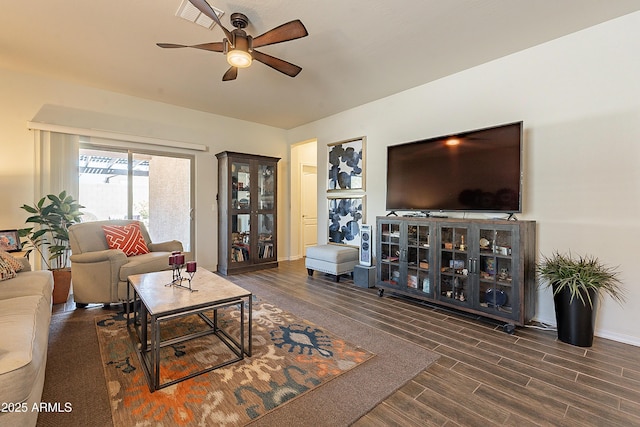 living area featuring visible vents, baseboards, wood finished floors, and a ceiling fan