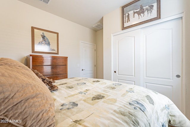 bedroom featuring a closet and visible vents