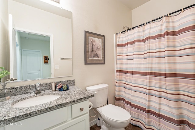 bathroom featuring vanity, toilet, and a shower with shower curtain