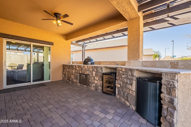 view of patio featuring exterior kitchen and ceiling fan