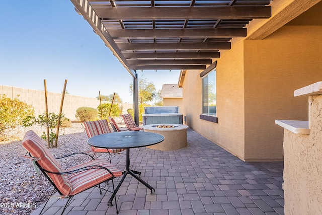 view of patio / terrace featuring fence, a pergola, and an outdoor fire pit