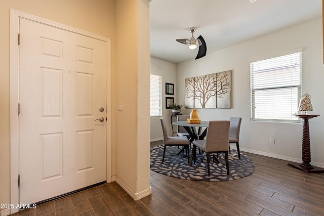 dining room with baseboards, a ceiling fan, and wood tiled floor