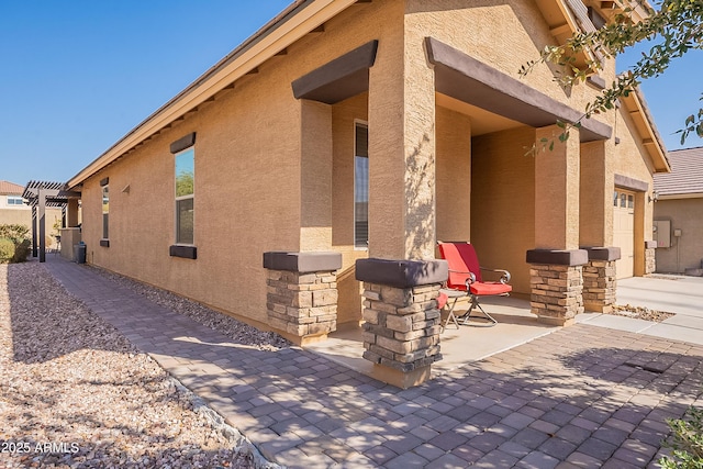 view of side of home with a pergola and a garage