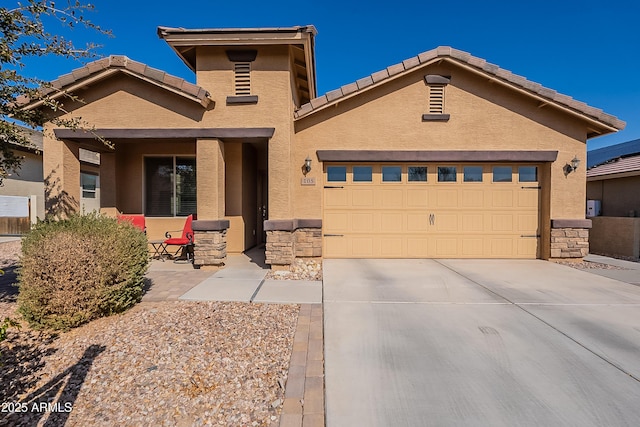 view of front of home featuring stone siding, driveway, and stucco siding