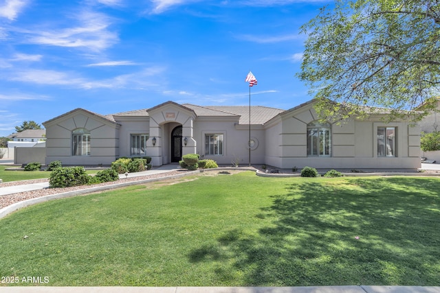 ranch-style home with a front lawn, stucco siding, and a tiled roof