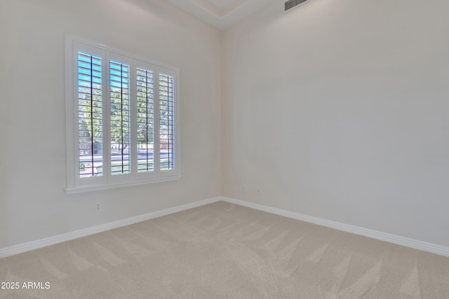 carpeted empty room with baseboards and visible vents
