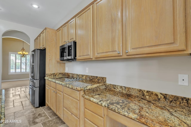 kitchen featuring an inviting chandelier, stone tile flooring, light brown cabinets, recessed lighting, and stainless steel appliances