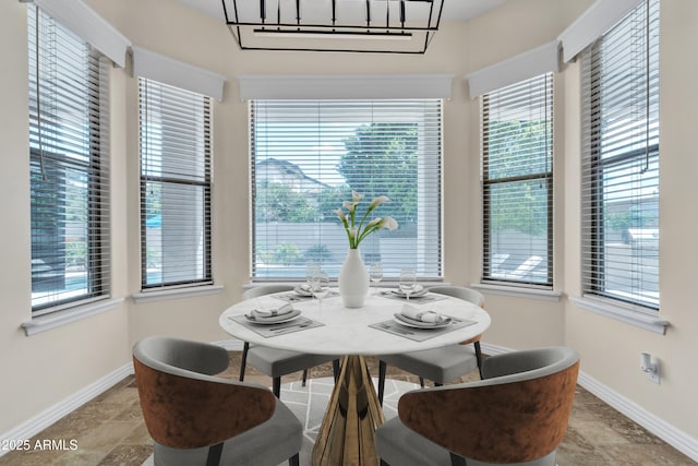 dining room featuring baseboards and stone finish floor
