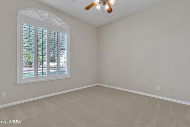 empty room with ceiling fan, carpet flooring, and a wealth of natural light