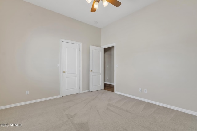 unfurnished bedroom with baseboards, carpet flooring, and a ceiling fan