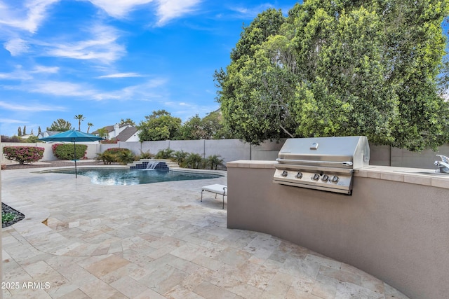 view of pool with exterior kitchen, grilling area, a fenced backyard, a fenced in pool, and a patio area