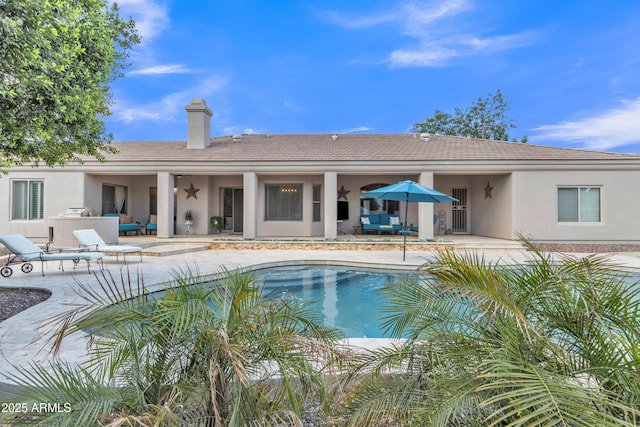pool with a patio and an outdoor living space