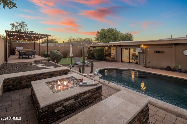 pool at dusk with a patio, a fire pit, and a pergola