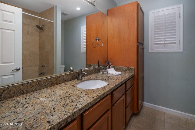 full bathroom featuring vanity, tiled shower / bath combo, tile patterned floors, and toilet