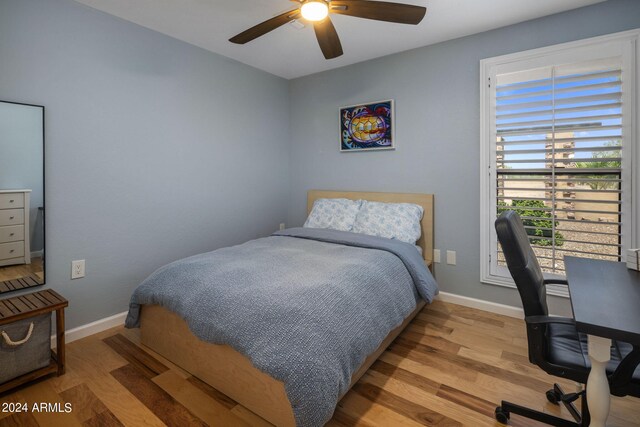 bedroom with ceiling fan and light wood-type flooring