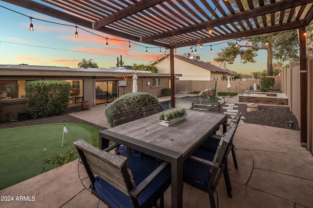 patio terrace at dusk featuring a pergola