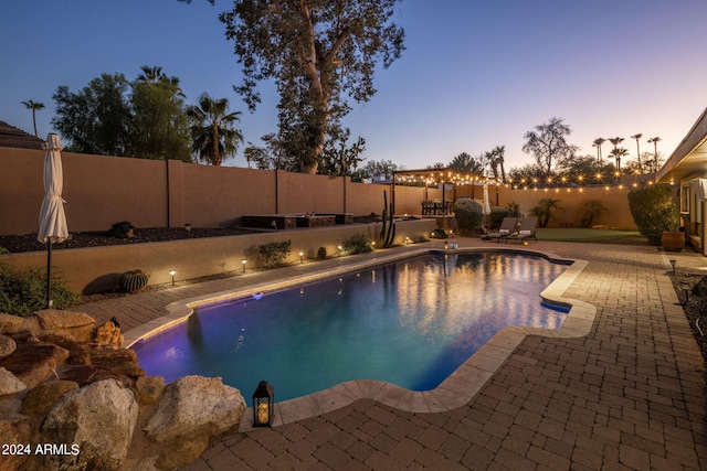 pool at dusk with a patio