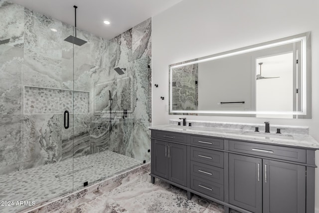 bathroom featuring vanity, ceiling fan, and walk in shower