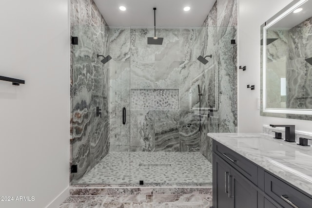 bathroom with a shower with door and vanity