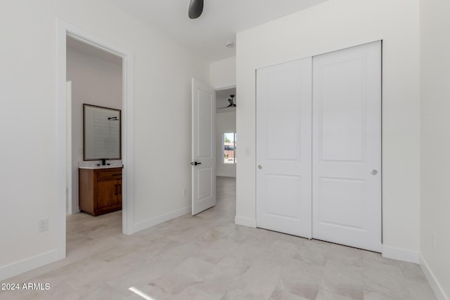 unfurnished bedroom featuring a closet and sink