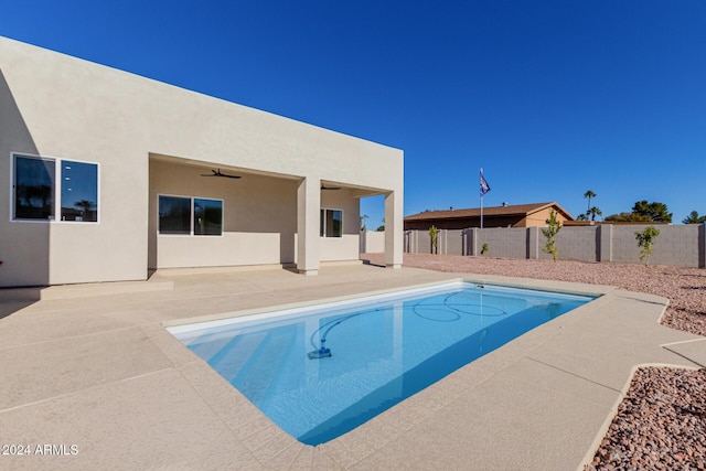 view of swimming pool featuring ceiling fan and a patio area