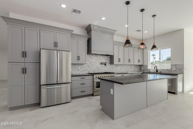 kitchen with gray cabinetry, stainless steel appliances, and hanging light fixtures