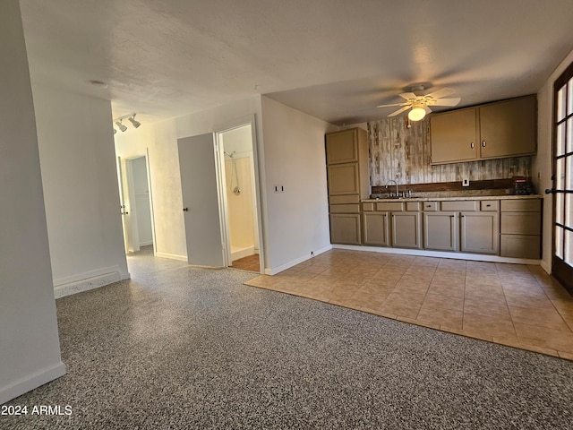 kitchen with ceiling fan, light tile floors, and sink