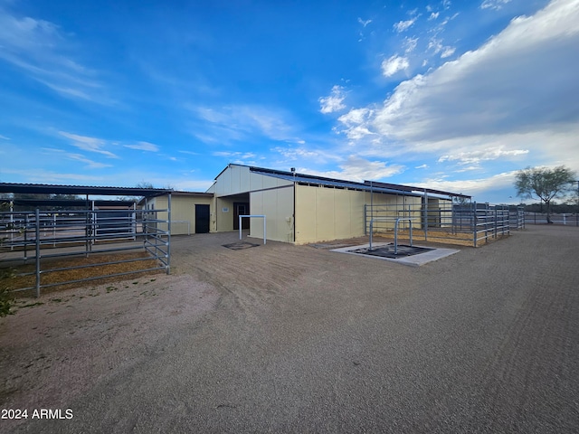 view of front facade with a rural view and an outdoor structure