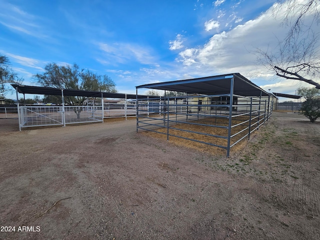 view of horse barn featuring a rural view and an outdoor structure