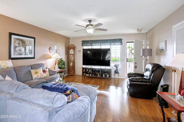 living room featuring a ceiling fan and light wood finished floors