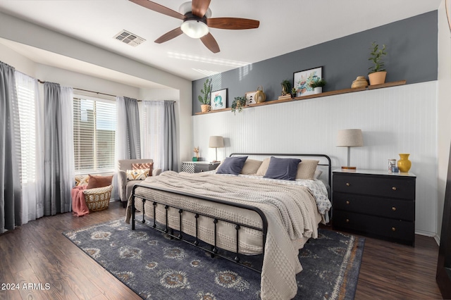 bedroom with dark hardwood / wood-style flooring and ceiling fan