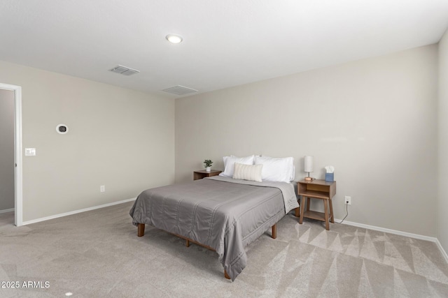 carpeted bedroom with visible vents and baseboards
