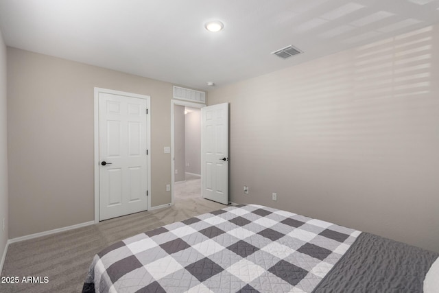 unfurnished bedroom with light colored carpet, baseboards, and visible vents