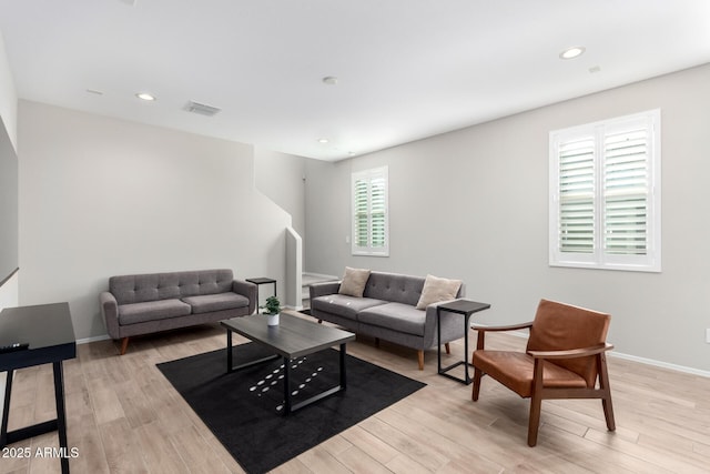 living room with visible vents, light wood-type flooring, and recessed lighting