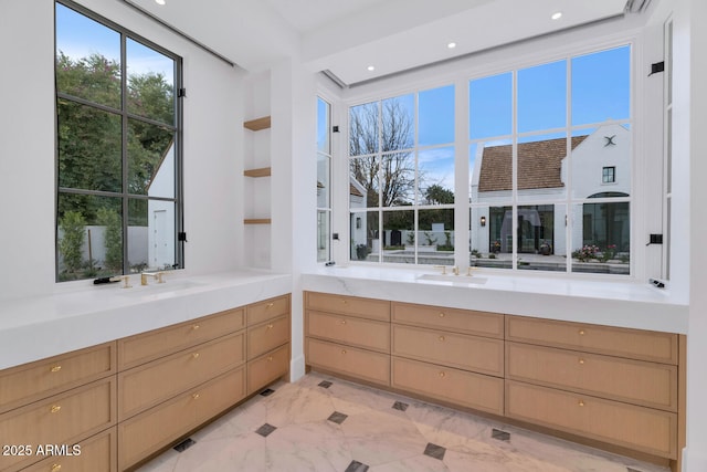 interior space with sink and light brown cabinetry