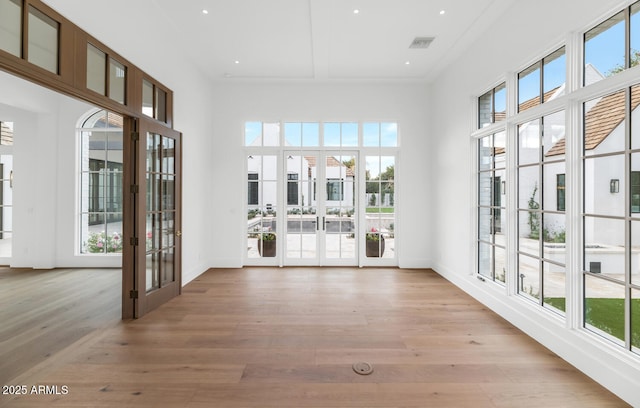 unfurnished sunroom with french doors and a healthy amount of sunlight