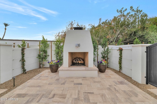 view of patio featuring exterior fireplace