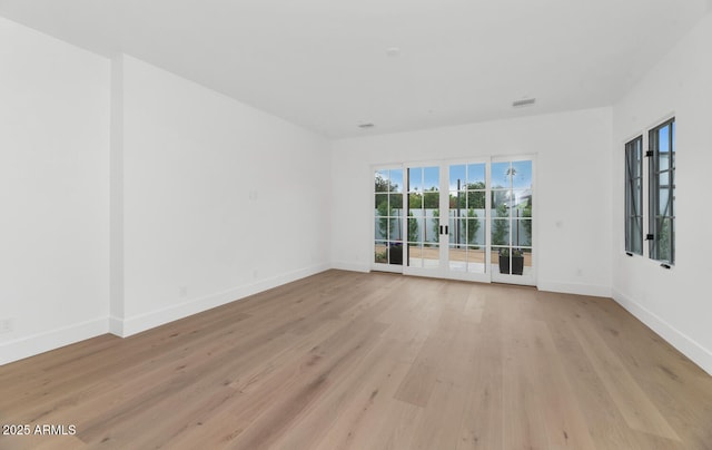 unfurnished room with light hardwood / wood-style flooring