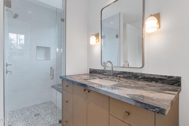 bathroom with vanity and a shower with door