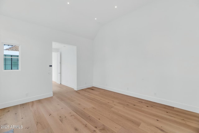 unfurnished room featuring light hardwood / wood-style flooring and vaulted ceiling