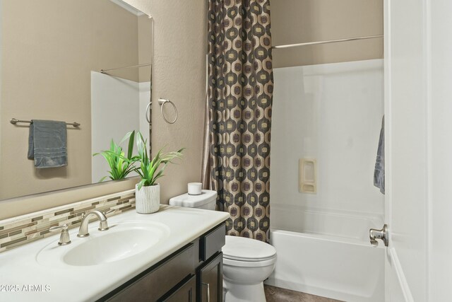 bathroom with toilet, decorative backsplash, a shower with shower door, and vanity