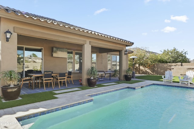 view of swimming pool with a patio area