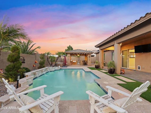 view of pool with pool water feature, a patio area, a gazebo, and a diving board