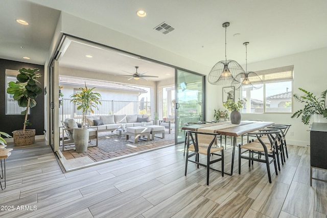 dining area with a wealth of natural light and ceiling fan