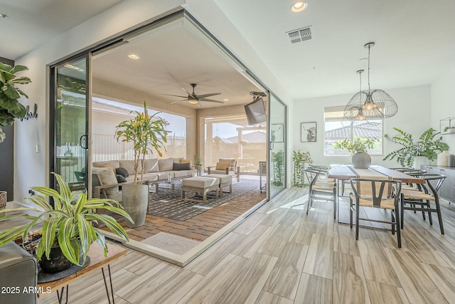 sunroom / solarium featuring ceiling fan